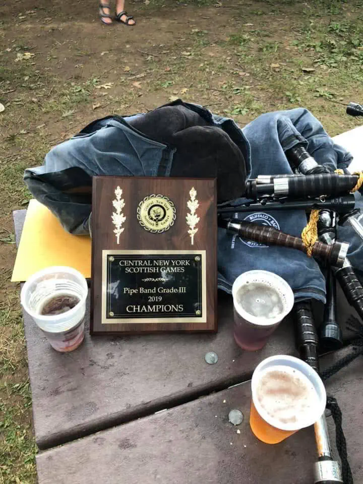 Central New York Scottish Games Grade III pipe band champions trophy dated 2019 beside bagpipes